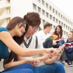 young couple student touching the smartphone