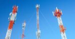 cell tower group with blue sky